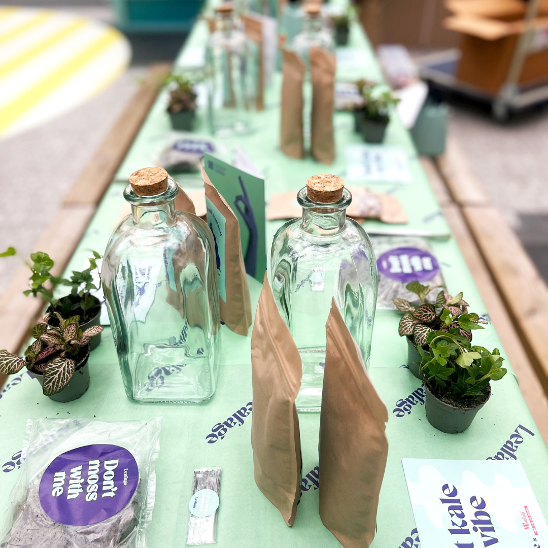 Woman speaking at a networking event with attendees seated at tables.